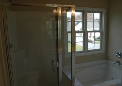 Tub and glass enclosed shower in the master bathroom