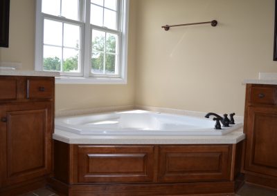 Master bathroom with tub and sinks